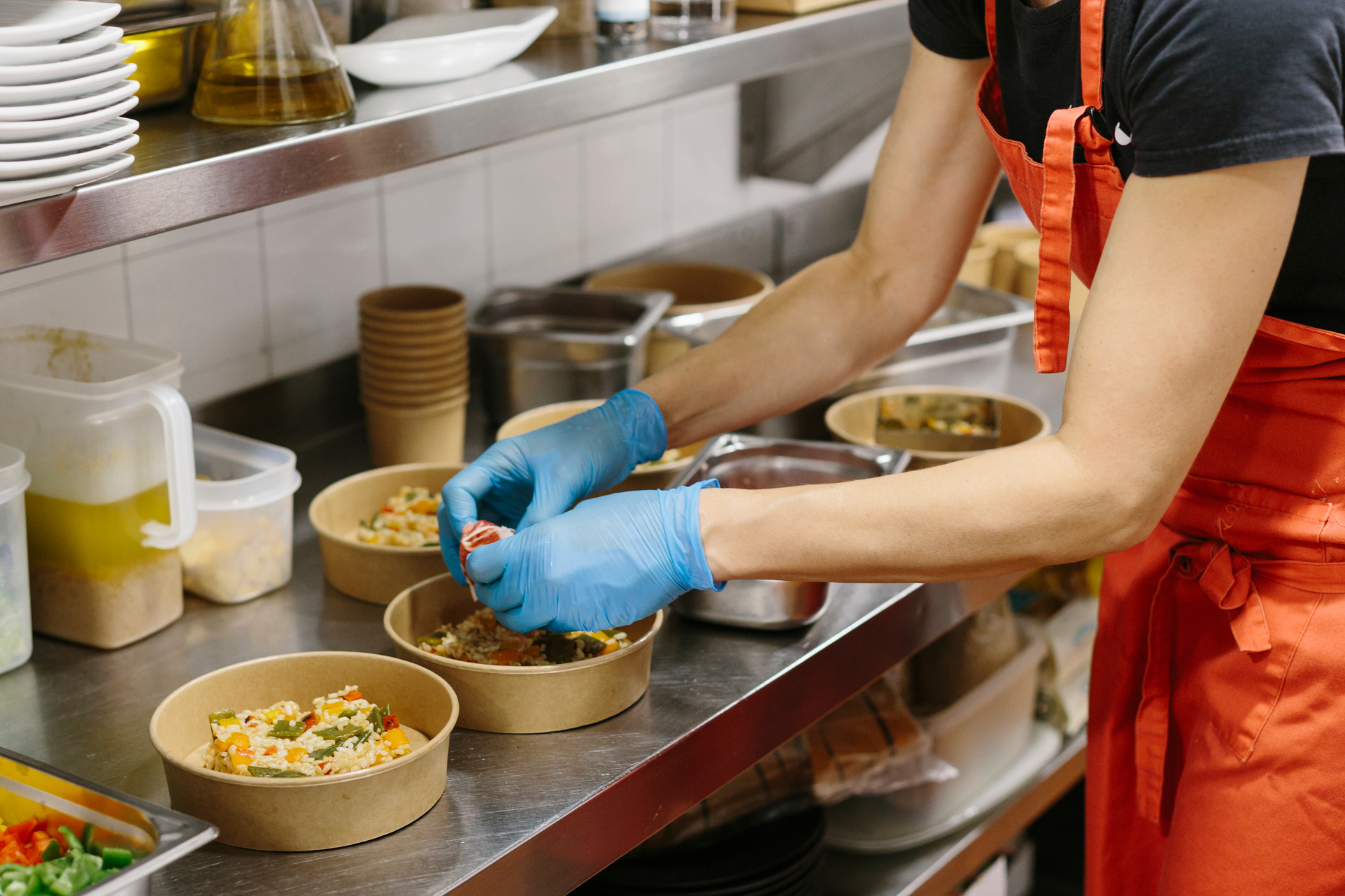 Cook preparing takeaway salads